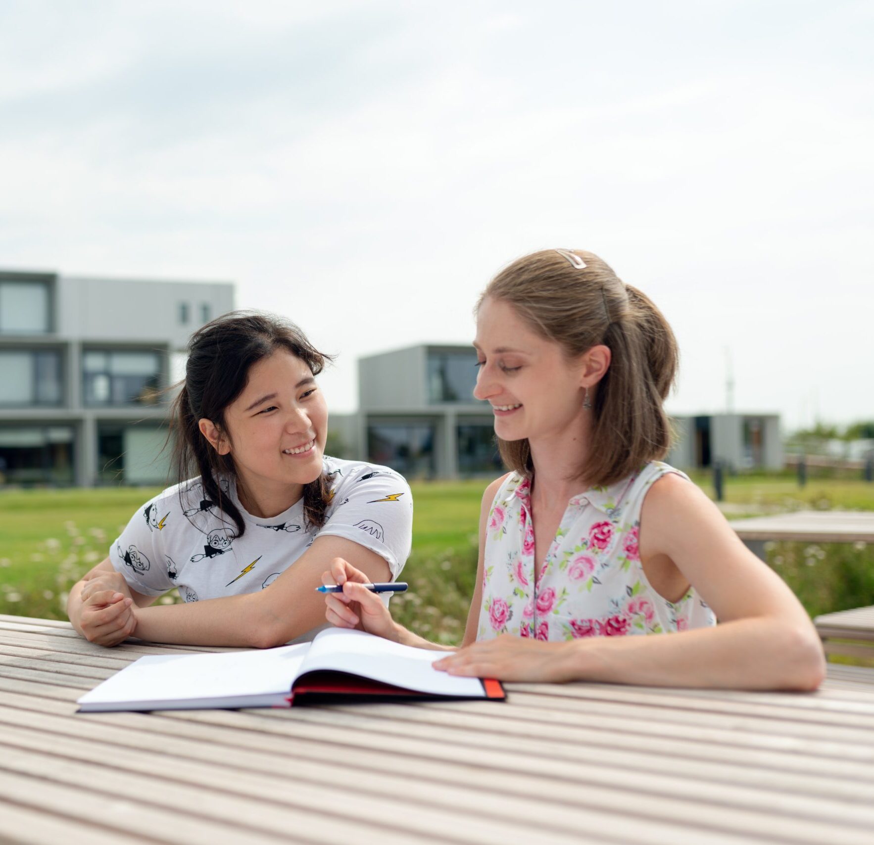 Two girls at an academic tutoring session outside